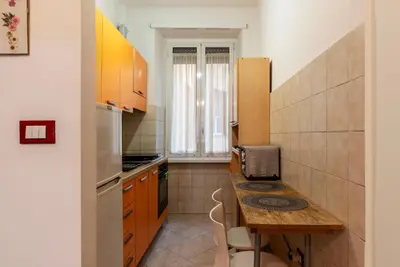 a kitchen with a table and a counter top at GuestHost - Piazzale delle Provincie Apartment in Rome