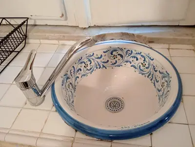 a bathroom sink with a fork on a tiled floor at Anna’s home in Rome