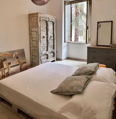 a bedroom with a large bed and a window at La Casa di Testaccio Apartment in Rome