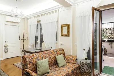 a living room with a couch and a table at Menotti elegant apartment in Rome