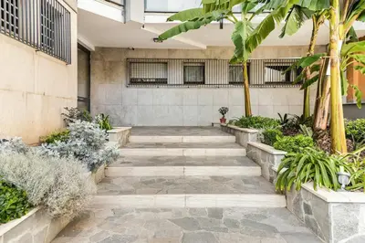 a stone walkway in a courtyard with plants at Menotti elegant apartment in Rome