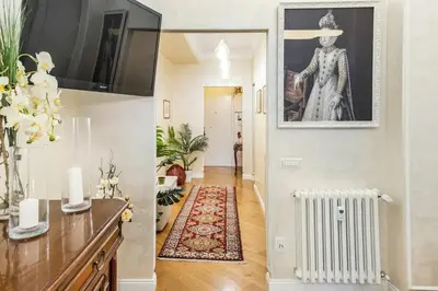a hallway with a living room with a picture on the wall at Menotti elegant apartment in Rome