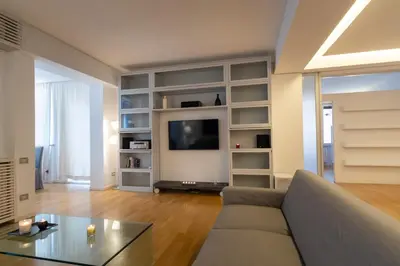 a living room with a couch and a tv at ArtStay - Luxury Penthouse Metro B, Tiburtina in Rome
