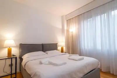 a bedroom with a large white bed with towels on it at ArtStay - Luxury Penthouse Metro B, Tiburtina in Rome