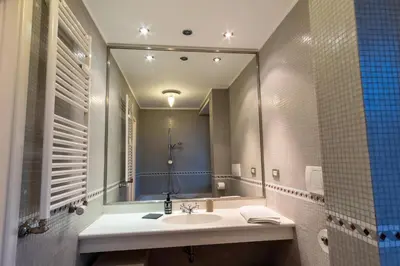 a bathroom with a sink and a large mirror at ArtStay - Luxury Penthouse Metro B, Tiburtina in Rome