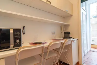 a kitchen with a counter with chairs and a microwave at ArtStay - Luxury Penthouse Metro B, Tiburtina in Rome
