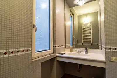 a bathroom with a sink and a mirror at ArtStay - Luxury Penthouse Metro B, Tiburtina in Rome