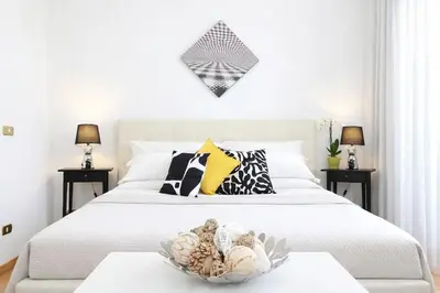 a bedroom with a bed with a bowl on a table at Luxury Apartment for 10 Central VATICANO S'Peter Basilica AirCond NETFLIX - SKY Wifi in Rome