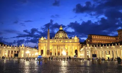 a building with the dome of a building at night at Luxury Apartment for 10 Central VATICANO S'Peter Basilica AirCond NETFLIX - SKY Wifi in Rome