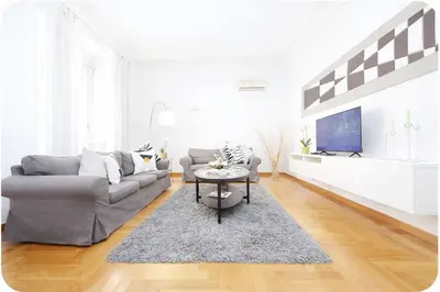 a living room with a couch and a table at Luxury Apartment for 10 Central VATICANO S'Peter Basilica AirCond NETFLIX - SKY Wifi in Rome