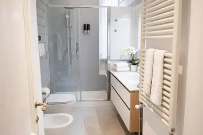 a bathroom with a shower and a toilet and a sink at Luxury Apartment for 10 Central VATICANO S'Peter Basilica AirCond NETFLIX - SKY Wifi in Rome