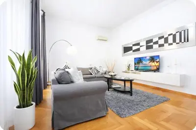 a living room with a couch and a table at Luxury Apartment for 10 Central VATICANO S'Peter Basilica AirCond NETFLIX - SKY Wifi in Rome