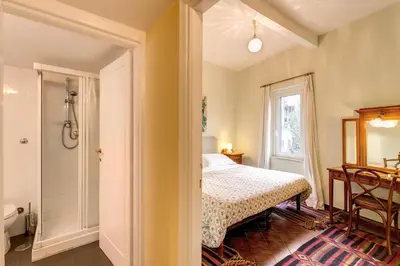 a bedroom with a bed and a walk in shower at Amazing penthouse with terrace near Navona Square in Rome