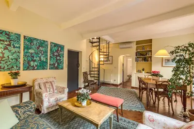 a living room with furniture and a table at Amazing penthouse with terrace near Navona Square in Rome