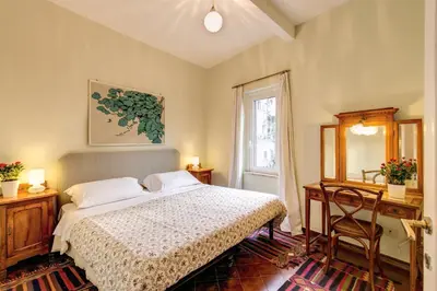 a bedroom with a bed and a mirror and a window at Amazing penthouse with terrace near Navona Square in Rome