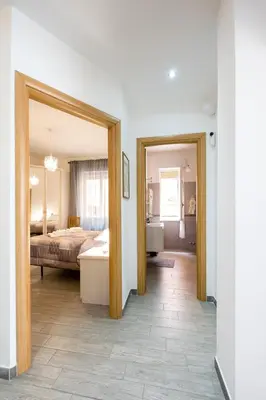 a bedroom with a bed and a mirror at La Maison de la Couturière in Rome