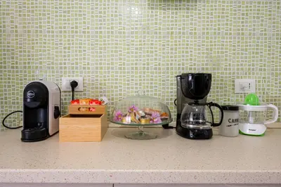 a kitchen counter with appliances on a counter top at La Maison de la Couturière in Rome