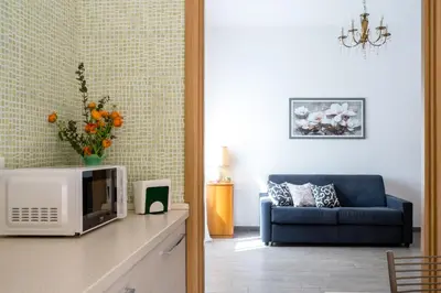 a living room with a microwave and a couch at La Maison de la Couturière in Rome