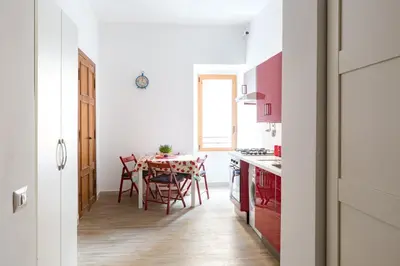 a kitchen and dining room with a table and chairs at Flat Between The Vatican and Piazza del Popolo in Rome