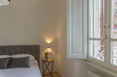 a bedroom with a bed and a window at Borgo Charme Elegante e Unico. Dimora da Sogno in Rome