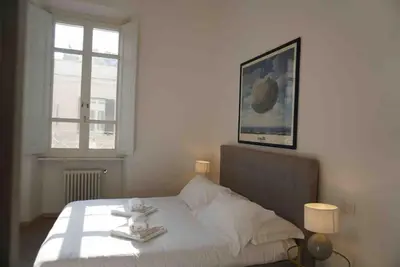 a bedroom with a bed with a teddy bear on it at Borgo Charme Elegante e Unico. Dimora da Sogno in Rome