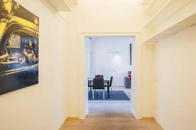 a hallway with a painting on the wall and a table at Borgo Charme Elegante e Unico. Dimora da Sogno in Rome