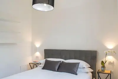 a bedroom with a white bed with two pillows at Borgo Charme Elegante e Unico. Dimora da Sogno in Rome
