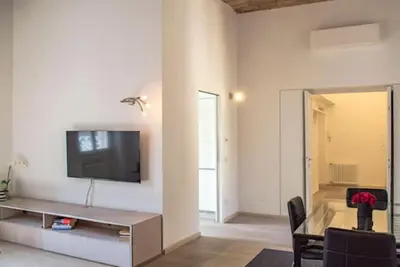 a living room with a flat screen tv on a wall at Borgo Charme Elegante e Unico. Dimora da Sogno in Rome