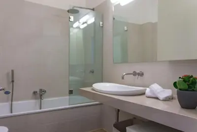 a bathroom with a sink and a shower and a tub at Borgo Charme Elegante e Unico. Dimora da Sogno in Rome