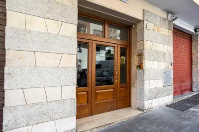 a building with a wooden door on the side of it at BDC - Euphoria 2BDR at Vatican in Rome