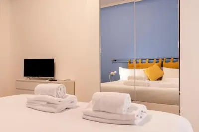 a bedroom with two beds and a mirror at BDC - Euphoria 2BDR at Vatican in Rome