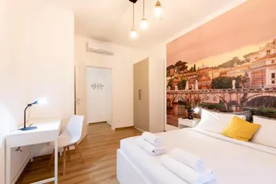 a white bedroom with a white bed and a desk at BDC - Euphoria 2BDR at Vatican in Rome