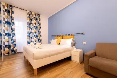 a bedroom with a large bed and a couch at BDC - Euphoria 2BDR at Vatican in Rome