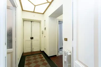 a hallway with white doors and a checkered floor at Borgo Plauto Oasi di Eleganza vicino al vaticano in Rome