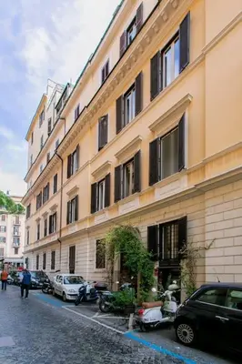 a building with cars parked on the side of a street at Borgo Plauto Oasi di Eleganza vicino al vaticano in Rome