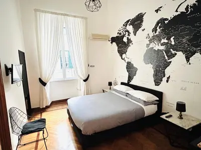 a bedroom with a large map of the world on the wall at B&B Gelsomina Apartment in Rome