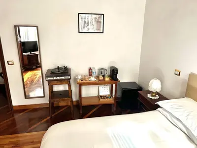 a bedroom with a bed and a table and a mirror at B&B Gelsomina Apartment in Rome