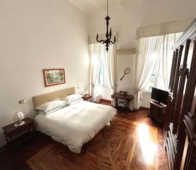 a bedroom with a large bed and a television at B&B Gelsomina Apartment in Rome