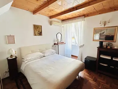 a bedroom with a white bed and a window at B&B Gelsomina Apartment in Rome