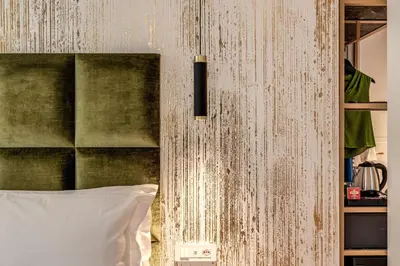 a bedroom with a bed with a wooden wall at Goldoni 47 in Rome