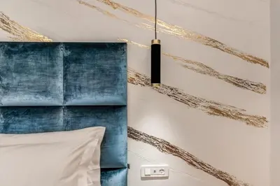 a bedroom with a bed with a blue headboard at Goldoni 47 in Rome