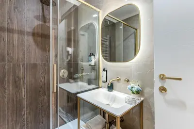 a bathroom with two sinks and a mirror at Goldoni 47 in Rome