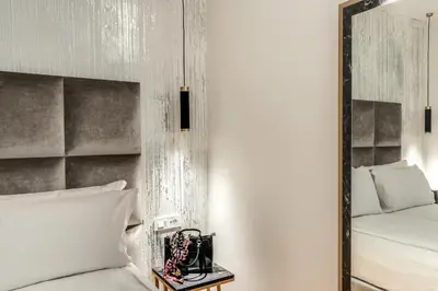 a bedroom with a mirror next to a bed at Goldoni 47 in Rome