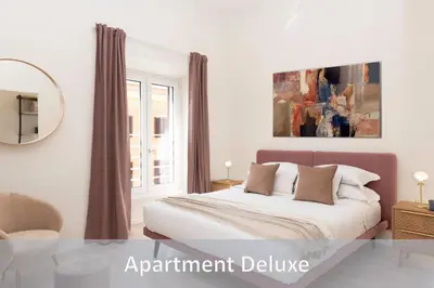 a white bedroom with a bed and a mirror at Best Vatican Apartment in Rome