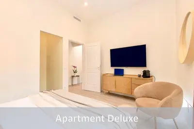 a living room with a television and a chair at Best Vatican Apartment in Rome