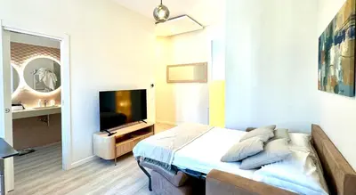 a bedroom with a bed and a television in it at Best Vatican Apartment in Rome