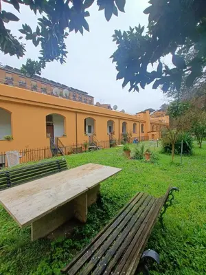 a wooden bench in front of a building at Trastevere in Loft Roma in Rome