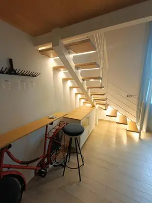 a room with a loft with a staircase and a tv at Trastevere in Loft Roma in Rome