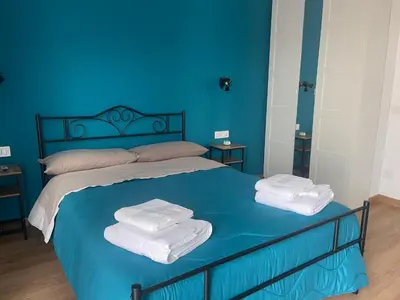 a blue bedroom with a bed with towels on it at Casetta Tuscolana in Rome