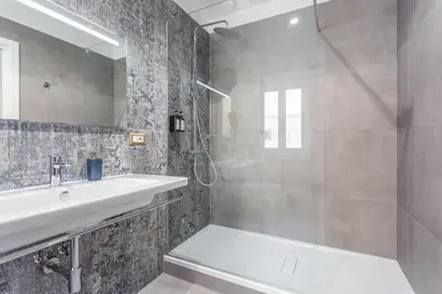 a bathroom with a tub and a sink and a shower at Rhome Vatican Rooms in Rome
